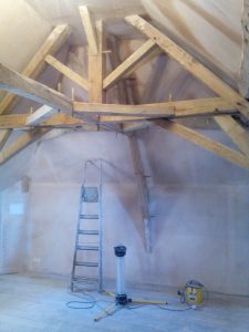 plastered room with high wooden beams